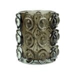 Ljuslykta i gråtonat glas med reliefmönster. Tung och gedigen modell som ger ett mjukt, dämpat sken. Ø 10 cm, höjd 11 cm.